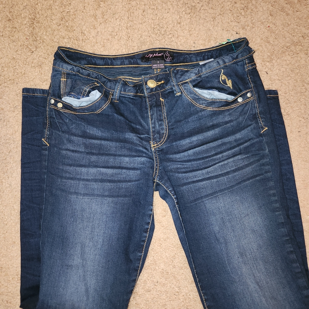 Baby Phat navy blue bootcut skinny jeans with gold stones details.